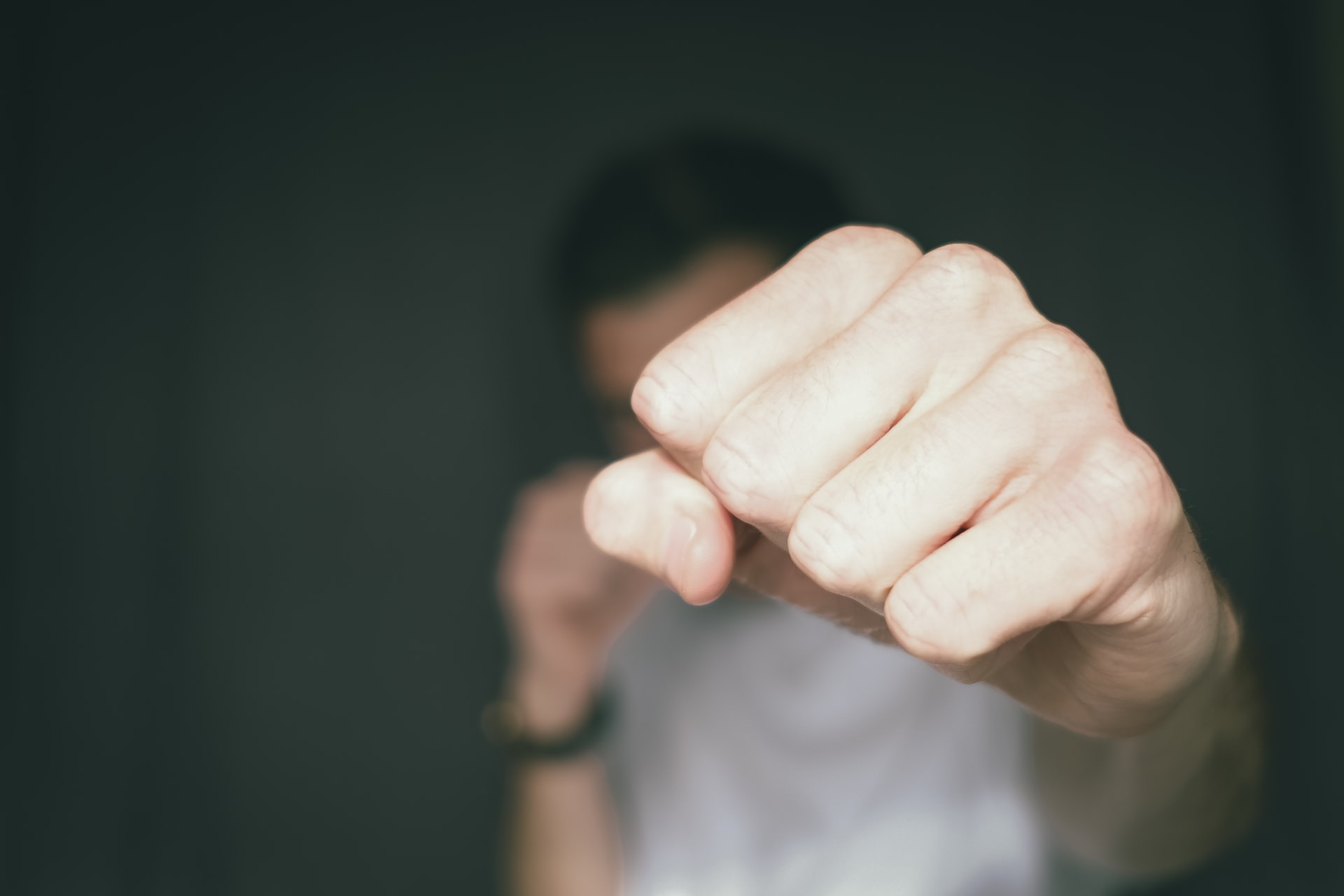 person holding fist to camera