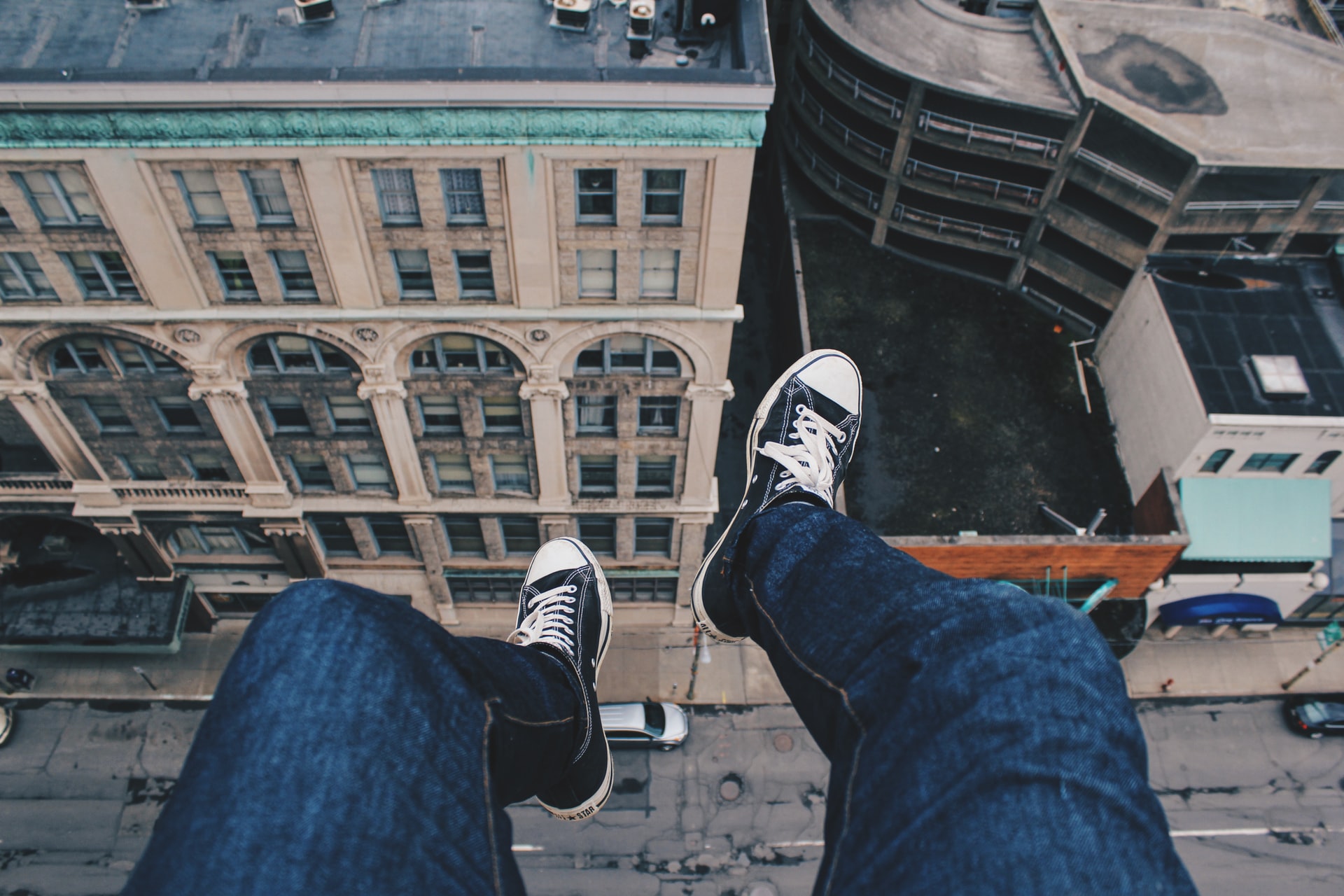Feet dangling from a building