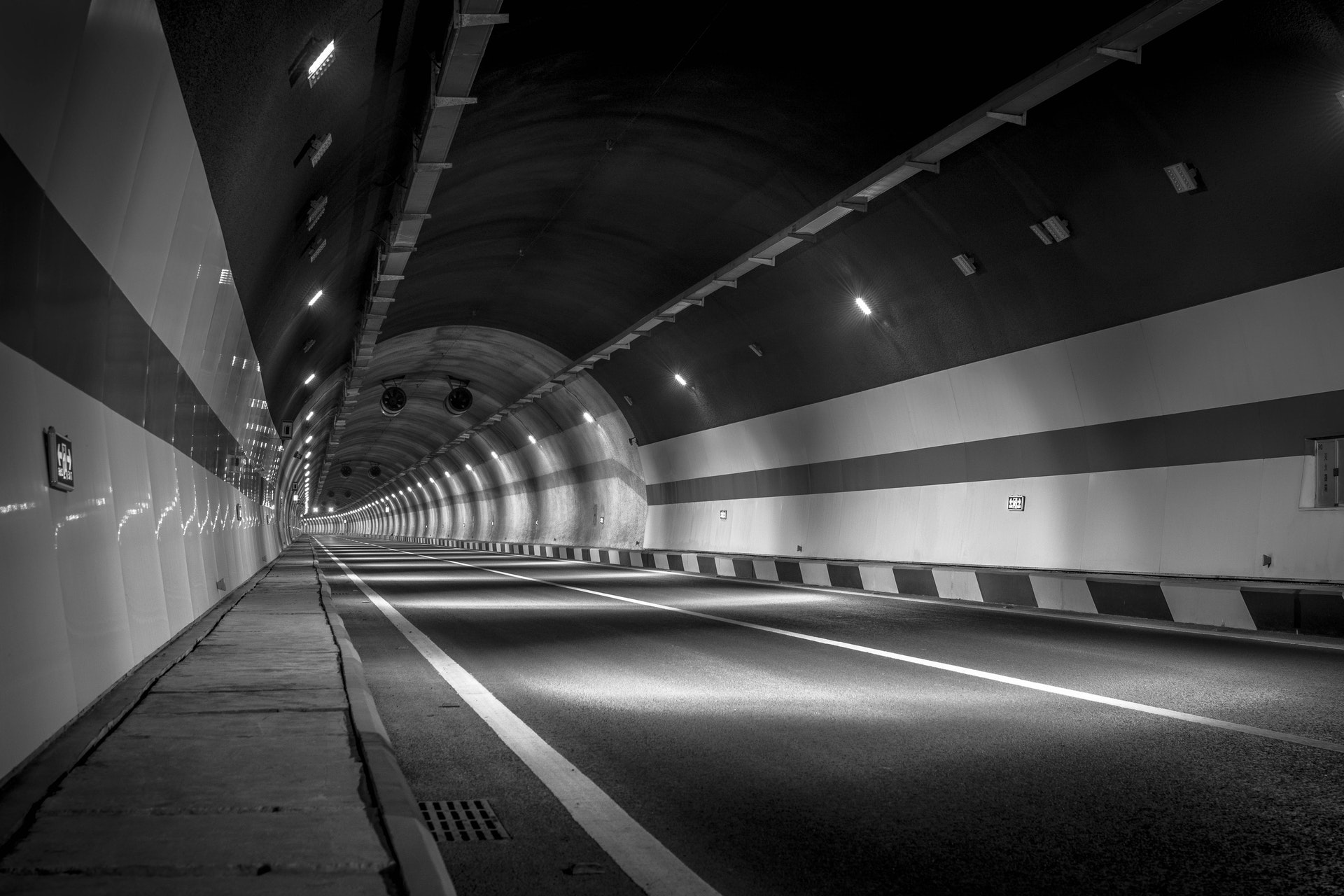 Grayscale photograph of an empty tunnel